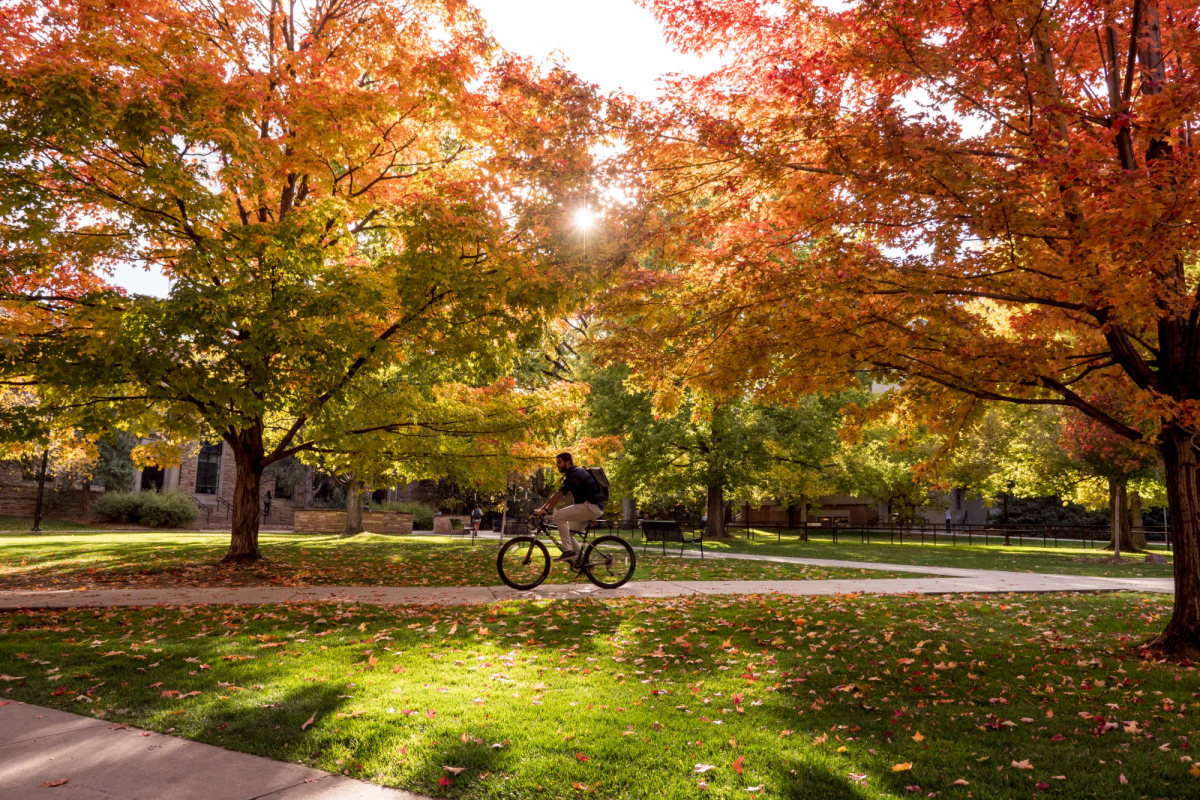 Student rides across campus in the fall