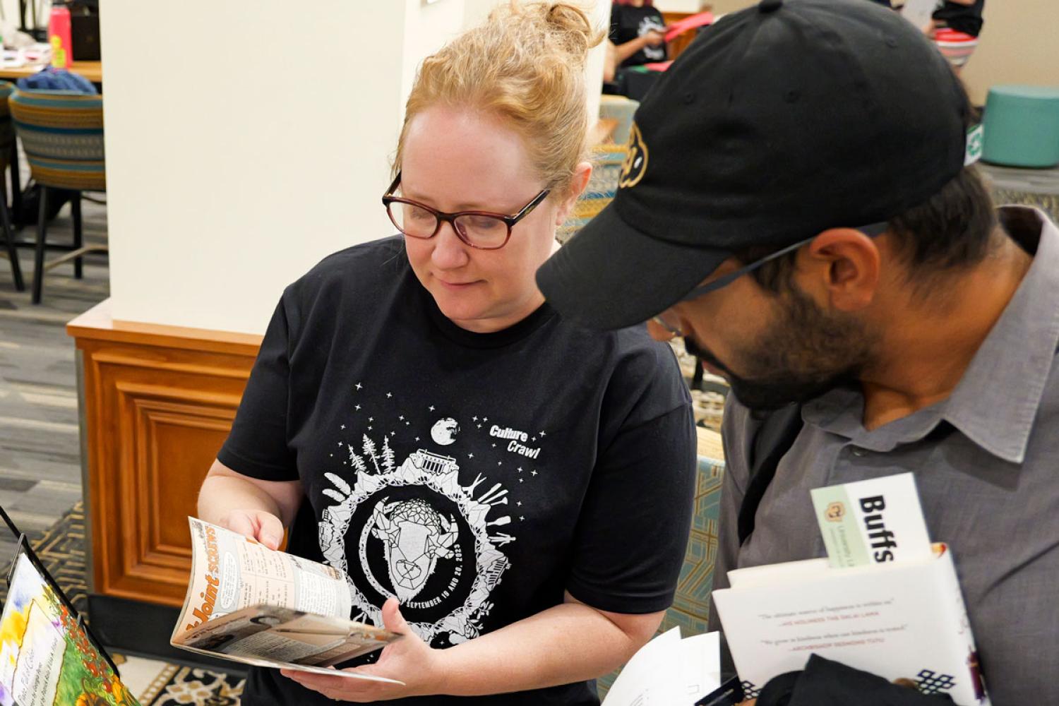 Students flip through books at the 2024 Culture Crawl event.