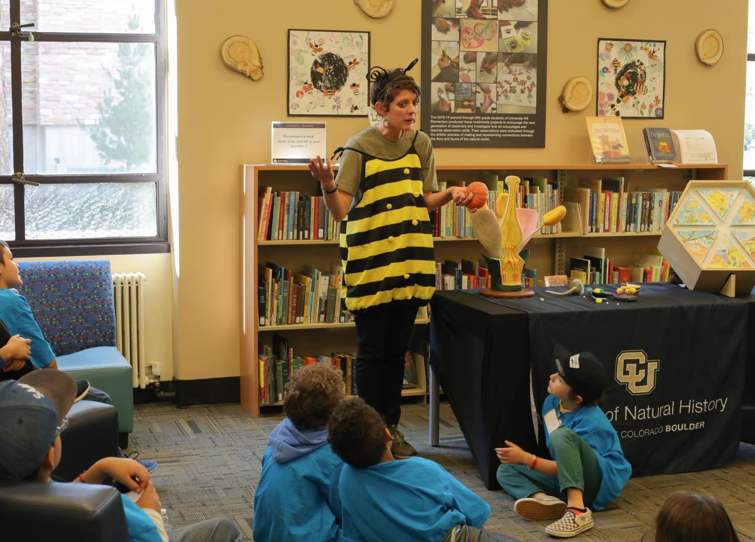 Elementary school students listen to bee in STEAM gallery