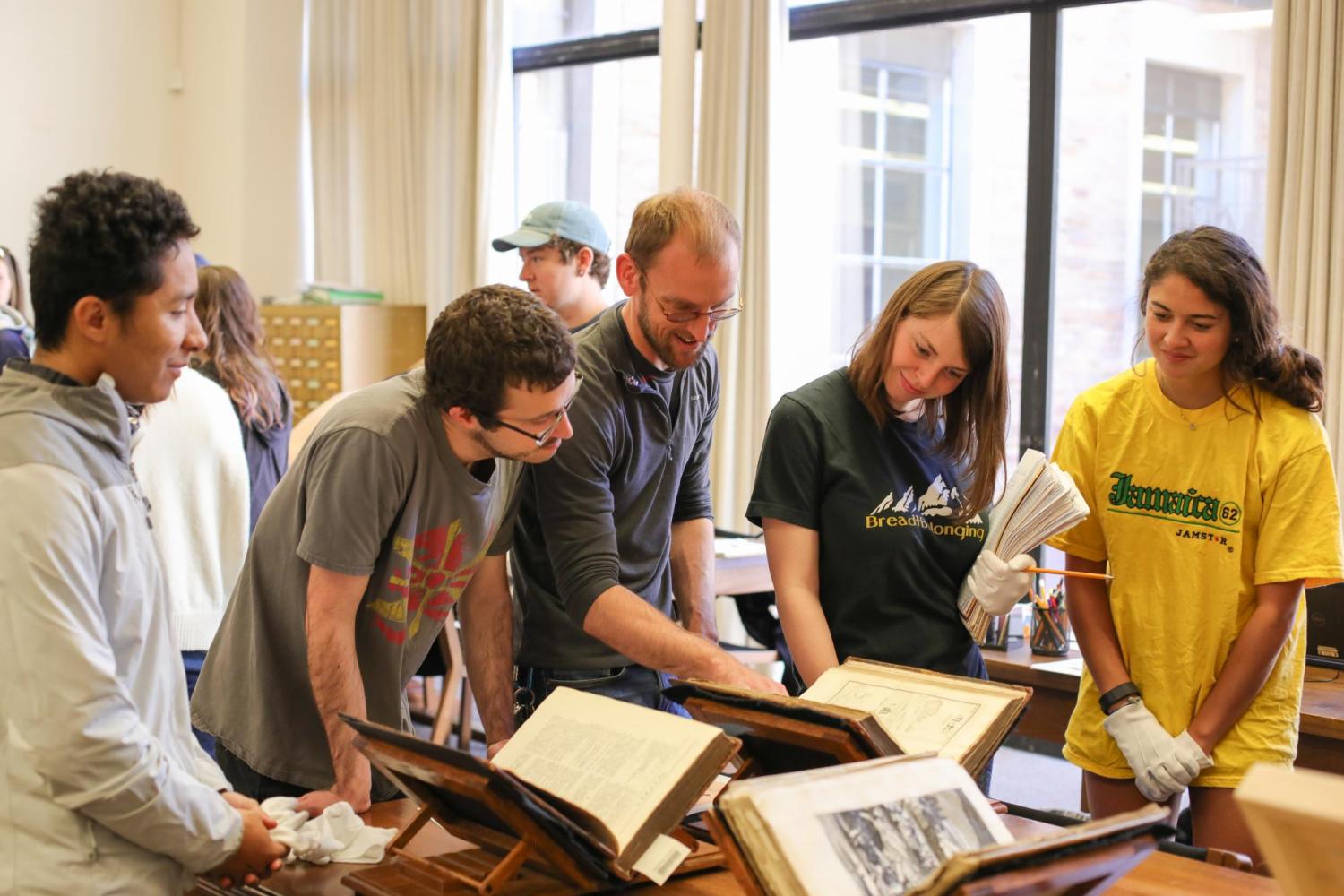 Librarian Adam Lisbon shows students from Asian Languages and Civilizations materials from Special Collections.