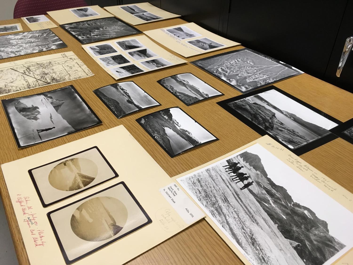 Several photos from the Glacier Collection spread across a table.