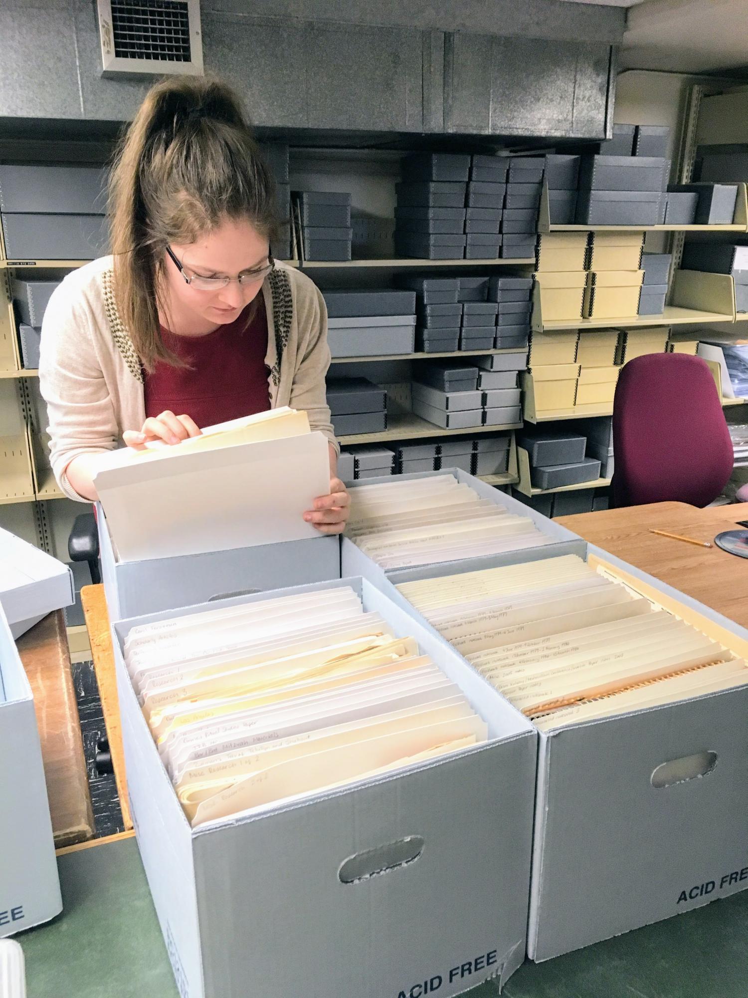 A student working in the Libraries' Archives, sorting papers.