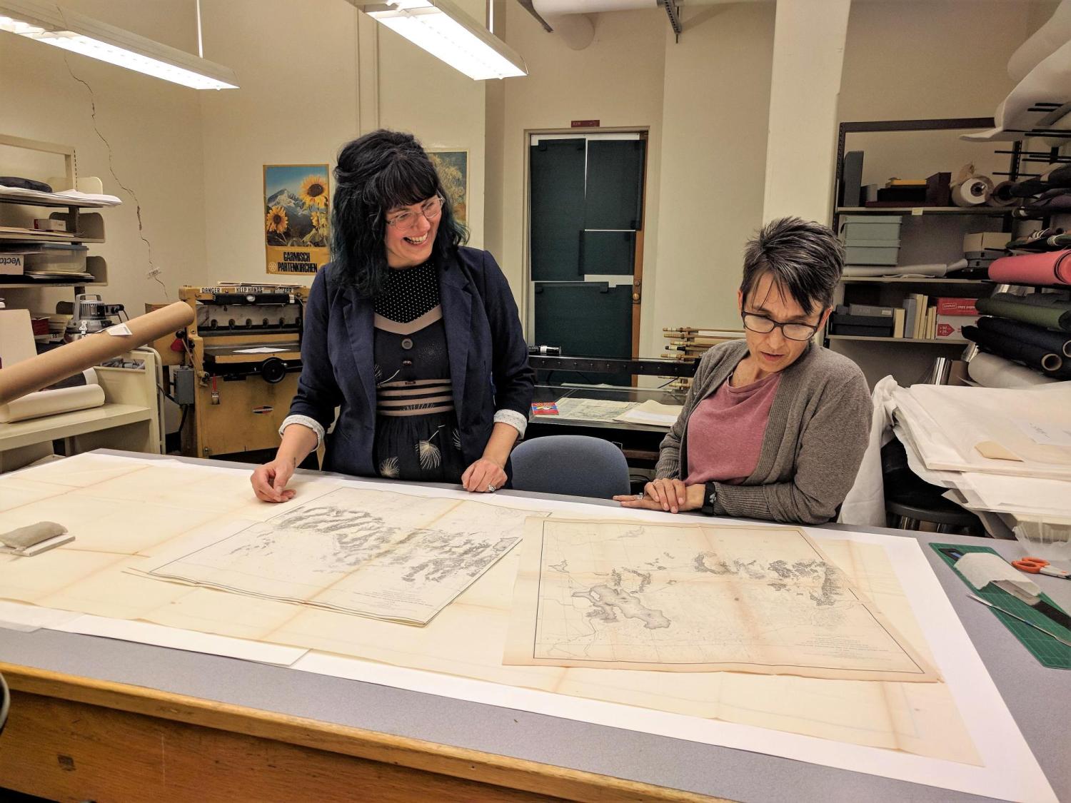 Interns Lisa Donavan and Stacey Brown work on maps from the U.S. Congressional Serial Set volumes in the Preservation unit.
