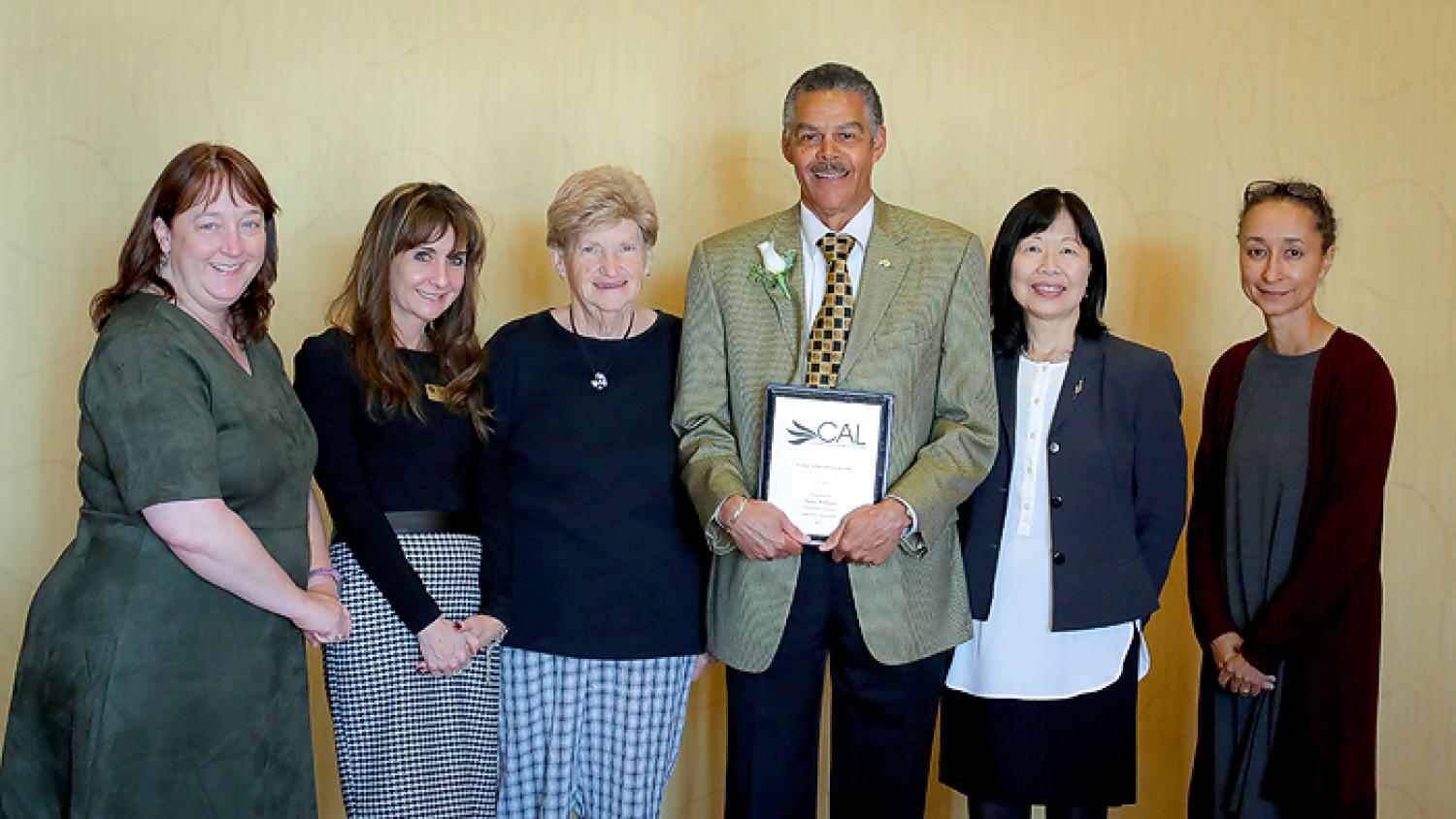 Jim Williams flanked by his supporters and peers from the University Libraries.