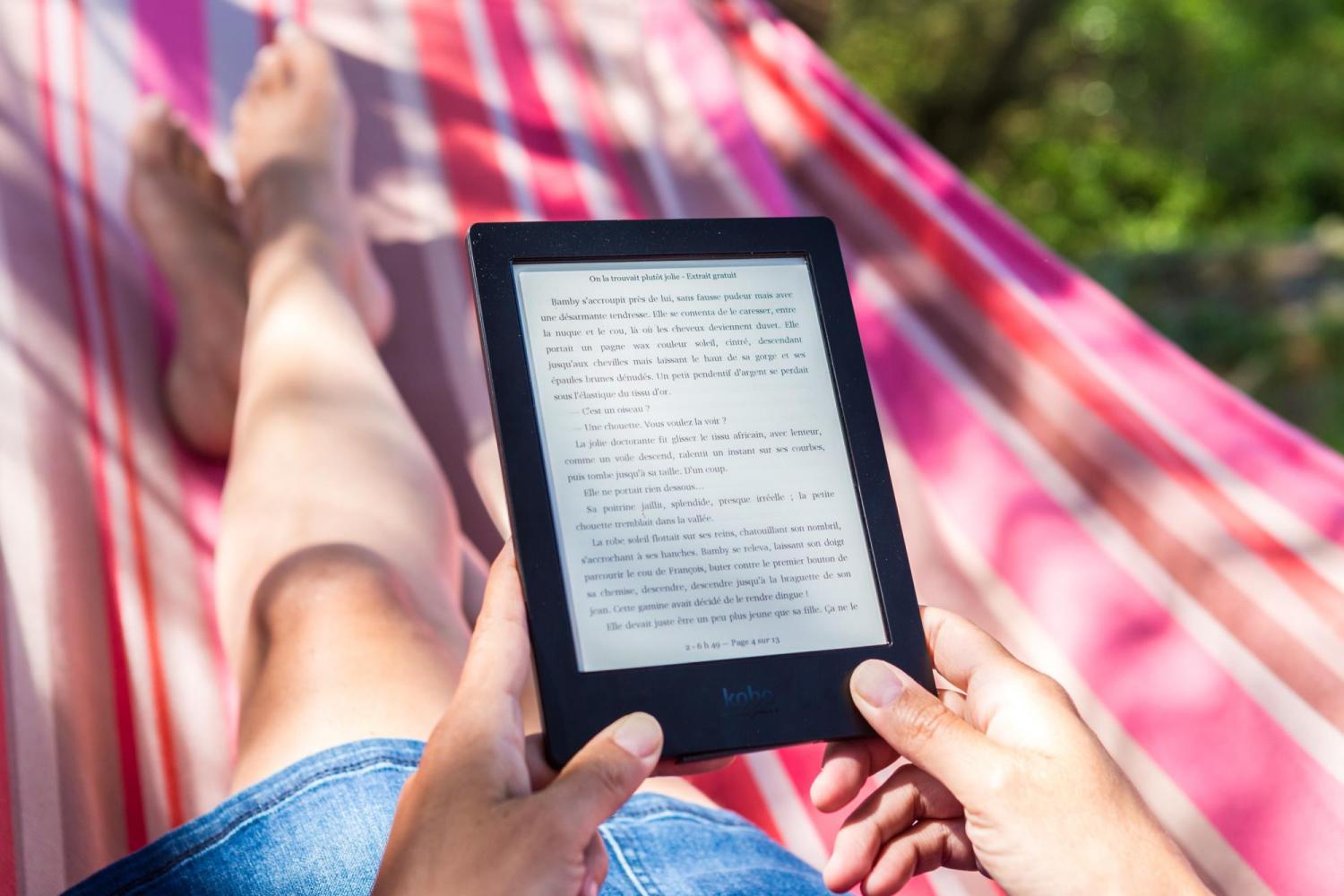 Woman reading ebook in hammock