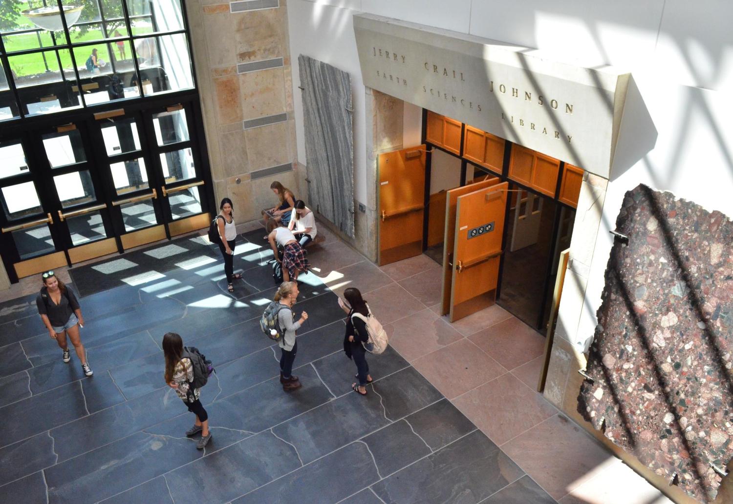 Lobby of the Benson Earth Sciences building showing people entering and leaving the Earth Sciences Library