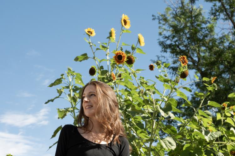 Abbey Lewis in front of campus sunflowers