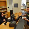 Circulation student assistant assists a patron at the desk of the Earth Sciences Library