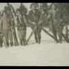 Black and white image of five women with ski gear in the snow, year unknown.
